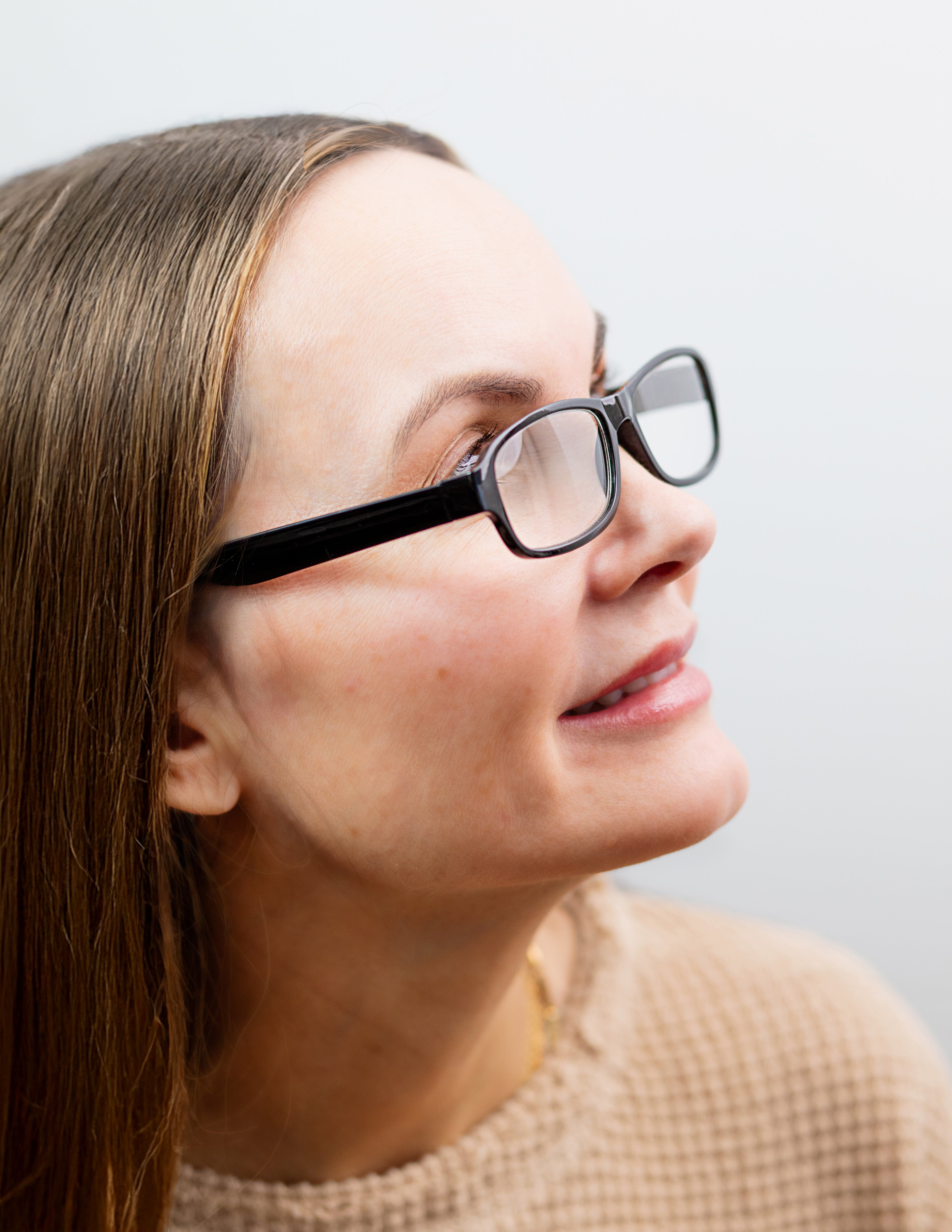 Woman wearing glasses with a neutral background