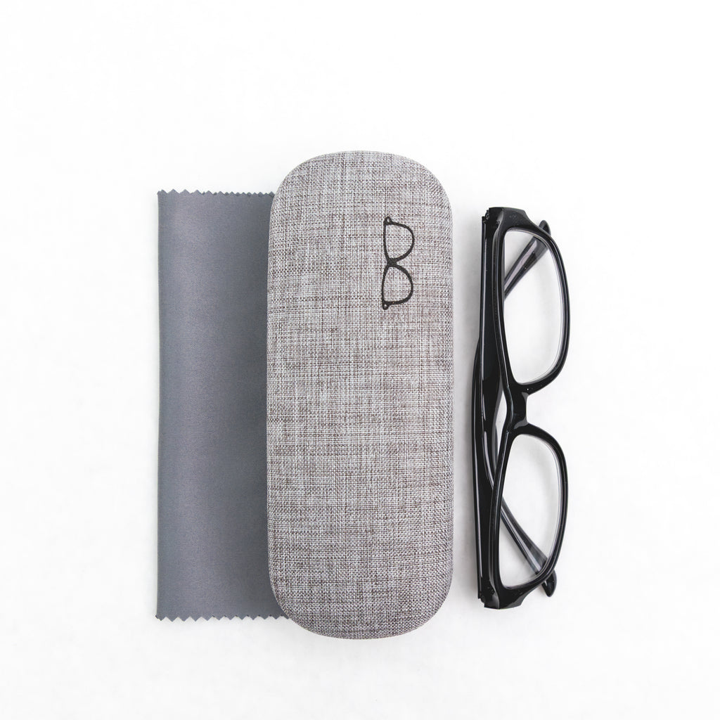 Gray eyeglass case with black glasses and a cloth on a white background