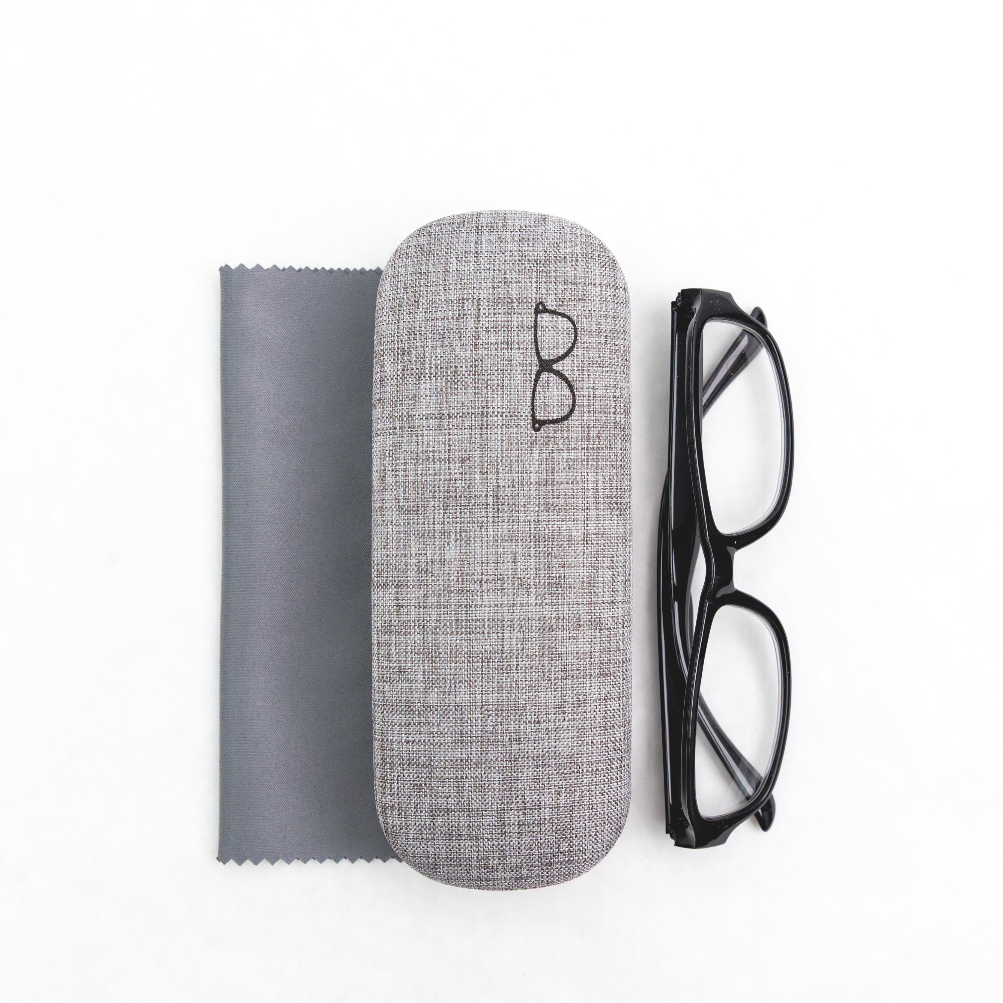 Gray eyeglass case with black glasses and a cloth on a white background