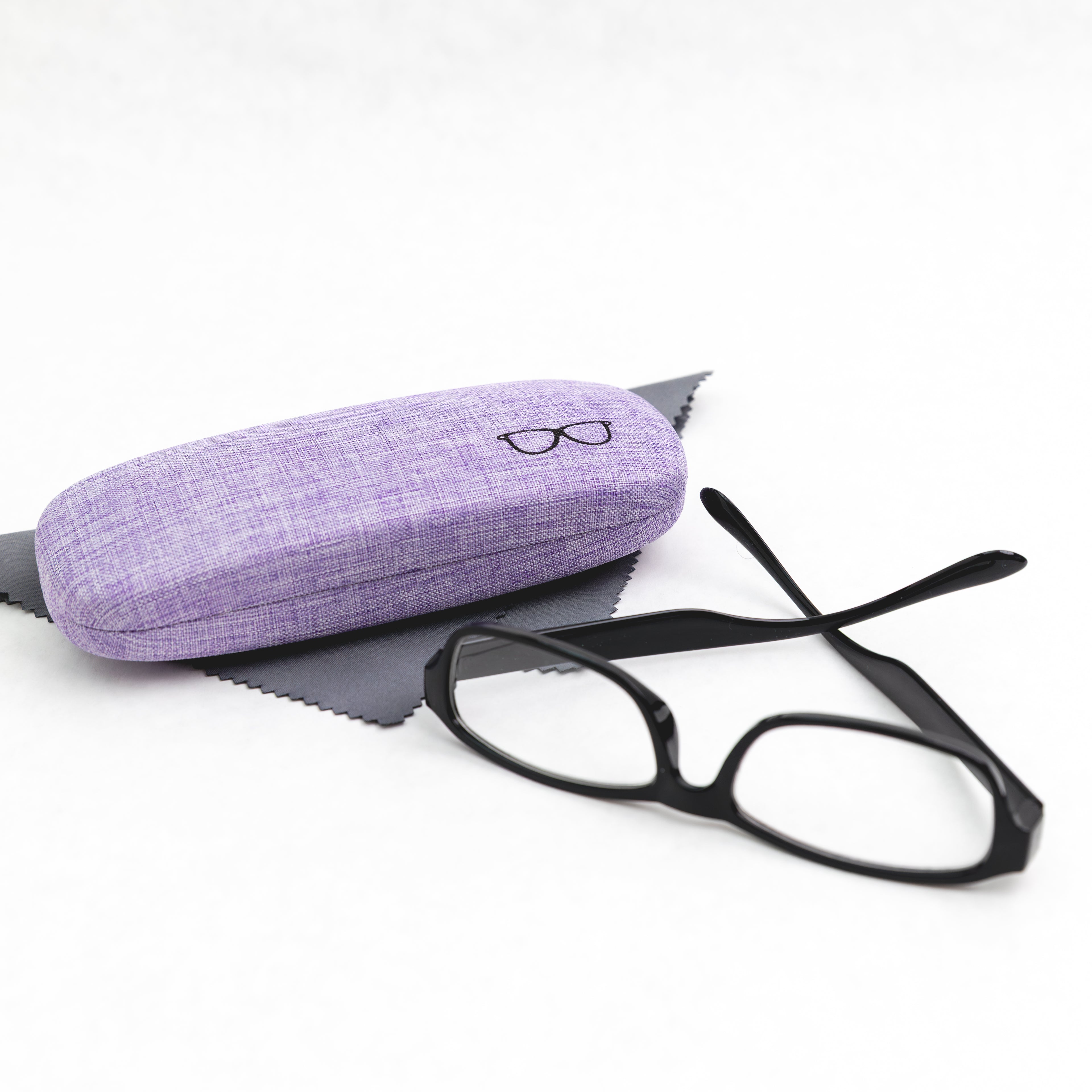 Black eyeglasses with a purple case on a white background