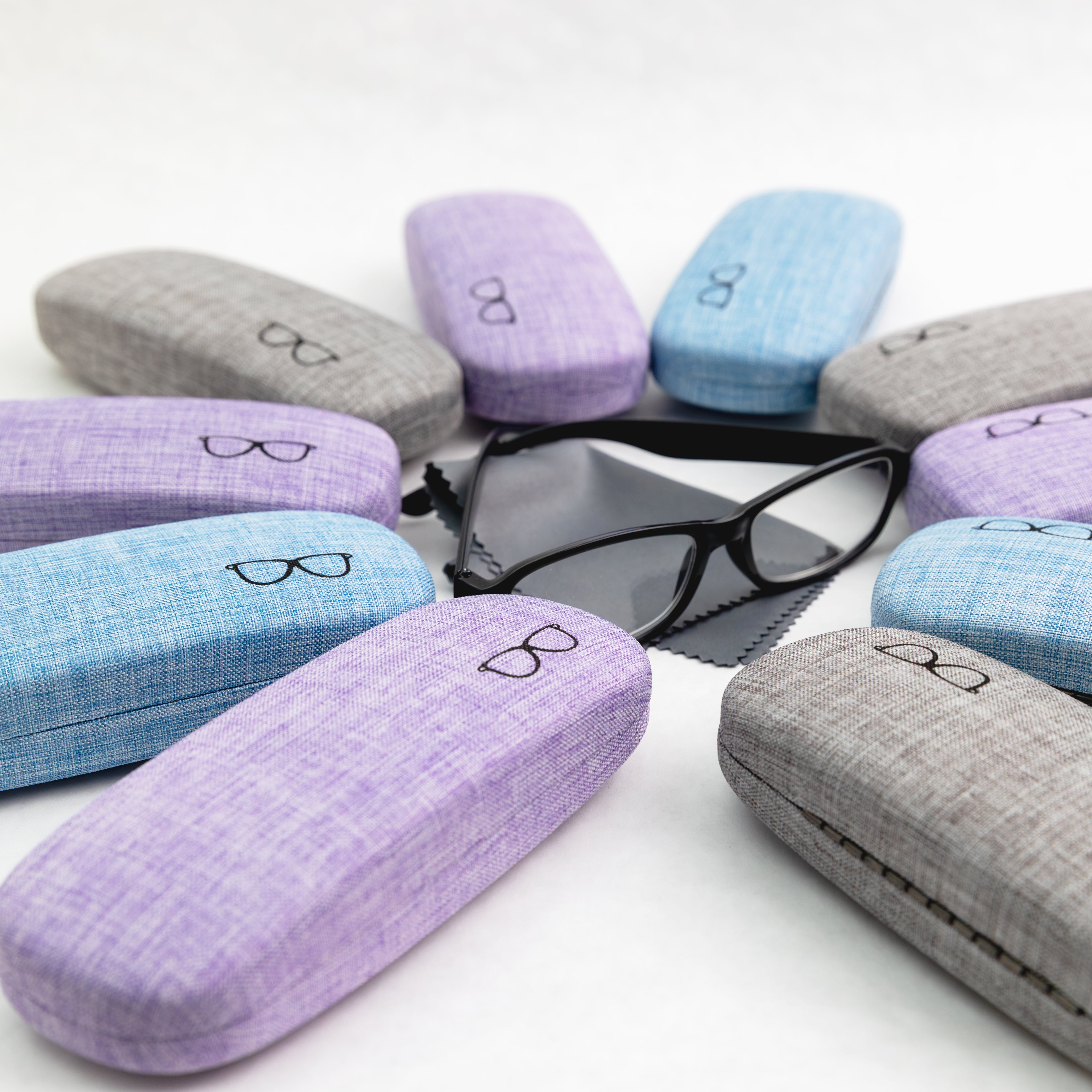 Collection of colorful eyeglass cases on a white background